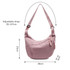 A pink Dumpling Crossbody Bag with an adjustable strap, featuring a zippered pocket and a simple design.