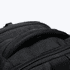 A black backpack featuring a sturdy handle and zippers. It is designed for durability and functionality.