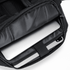 A black backpack with a zippered compartment containing a laptop and an iPad inside.