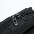 A black backpack featuring sturdy zippers and textured fabric details, with a logo present on the surface.