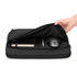 A black laptop sleeve with a zip opening, containing a notebook, pens, and a mouse inside.
