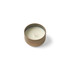 A round, brown mini tin candle with a smooth, white wax interior and a single wick.