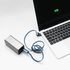 A silver charging device connected to a laptop with a blue 3-in-1 charging cable.
