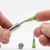 A visible demonstration of how the nectar needle fits comfortably inside small chambers for filling. 