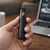 and holding Astro black vape hardware