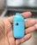 Compact D121 1 gram disposable vape hardware held in hand showing blue body and oil window
