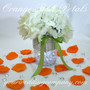 Orange Rose Petals Surround a Wedding Centerpiece