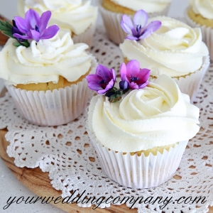 Wedding Cupcakes with Purple Flowers on a Doily