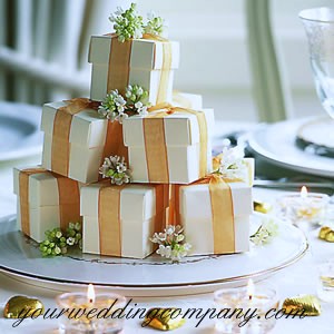 Stacked Cream Favor Boxes With Orange Ribbon and White Flower Accents