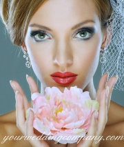 Beautiful bride holding a pink flower