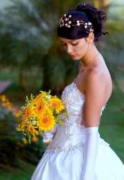 Beautiful bride holding a yellow wedding bouquet.