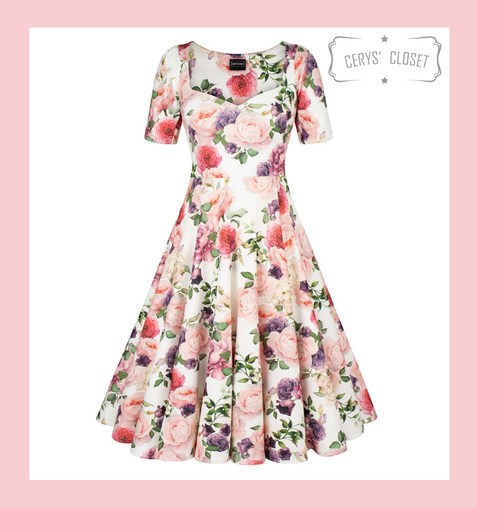 1950s vintage inspired full circle dress by Cerys' Closet. Made in the UK. Dress can be worn with or without the petticoat. Has a 4 panel full circle skirt with seam pockets, a sweetheart neckline and sleeves.

Stunning white background with floral print, ideal as an alternative wedding dress, wedding guest dress and bridesmaid  dress. 