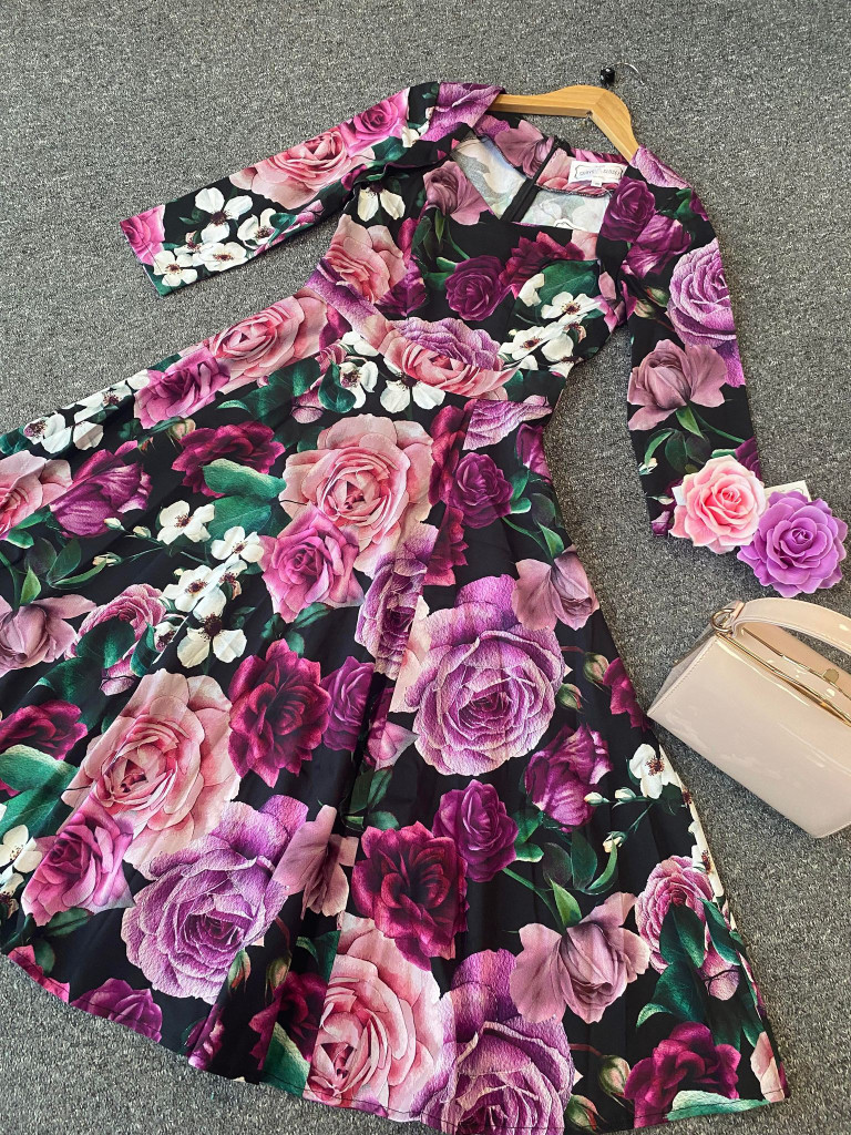 Vintage 1950s Inspired Purple, Pink and Black Floral Swing Dress with 3/4 Sleeves and Sweetheart Neckline by Cerys' Closet. A mixture of beautiful purple, burgundy, light purple, pink and white flowers with green foliage. Available in sizes 8 to 26