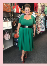 Emerald green 1950s vintage inspired full circle dress by Cerys' Closet. Made in the UK. Dress can be worn with or without the petticoat. Has a 4 panel full circle skirt with seam pockets, a sweetheart neckline and sleeves. Worn by @lisaredlips