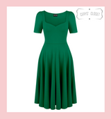 Emerald green 1950s vintage inspired full circle dress by Cerys' Closet. Made in the UK. Dress can be worn with or without the petticoat. Has a 4 panel full circle skirt with seam pockets, a sweetheart neckline and sleeves.