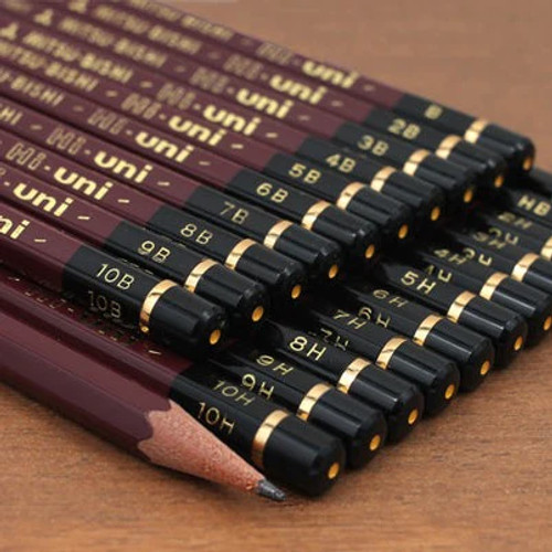 full range of mitsubishi hi uni  pencils on a tan background