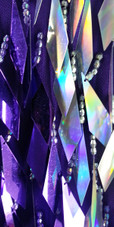 A short handmade sequin dress, with diamond-shaped metallic silver and purple sequins close up view