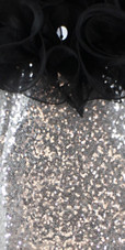 Short Silver Sequin Fabric Dress With Black Ruffles At Neckline Close View