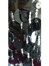 A long handmade sequin dress, in 20mm black paillette sequins with silver faceted beads and a luxe grey fabric background in a one-shoulder cut close up view