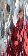 A long handmade sequin dress, in silver and red diamond shaped paillette hanging sequins with sweetheart neckline close view