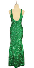 A long handmade sequin dress, in 8mm cupped metallic emerald green sequins back view