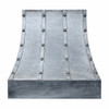 Handcrafted wrought iron range hood with riveted strap design and controlled bell silhouette with softened vertical curvature