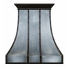 Loft style iron range hood with curved panels featuring a tall sculpted bell profile