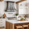 Loft style iron range hood with curved panels in a transitional style kitchen