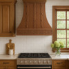 designer copper range hood with a Gothic apron in a traditional style kitchen featuring classic cabinetry, warm finishes, and handcrafted details