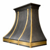 Side view of a zinc range hood with brass straps and apron, black crown molding