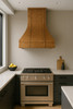 Antique copper range hood in contemporary kitchen, hand hammered copper canopy with riveted straps creating warm contrast with sleek cabinetry and clean surfaces