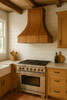 Antique copper range hood in farmhouse kitchen, hand hammered copper canopy with riveted straps above natural wood cabinetry and rustic architectural details