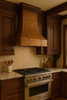 Antique copper range hood in American traditional kitchen, hand hammered copper canopy with riveted straps above classic cabinetry and timeless architectural details