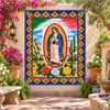 Mexican tile mural lady of Guadalupe displayed in a garden sanctuary with lush greenery.