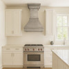 Transitional kitchen with brushed zinc range hood, crowned bell silhouette, clean cabinetry, and stone countertops