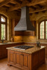 Handmade raw natural iron range hood with tapered bell silhouette 36-inch installed above an island in a Spanish revival kitchen