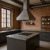 Handmade raw natural iron 30-inch range hood with tapered bell silhouette in a large loft style kitchen with a unfinished brick wall