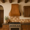 Faceted bell copper range hood in a California Mission kitchen