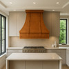 Custom copper kitchen hood in a contemporary kitchen with sleek cabinetry and minimalist surfaces