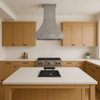 Architectural zinc range hood with flared canopy and crown detail in kitchen island setup, smooth zinc surface above central cooktop with refined silhouette