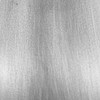 Close-up of iron range hood finish with riveted straps, flared collar, and hand-forged surface texture