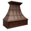 Decorative copper kitchen range hood angled view, hammered copper canopy with dark riveted straps and carved grapevine apron detail
