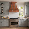 Transitional kitchen with gray shaker cabinets, stone counters, and hammered copper range hood with vertical zinc straps