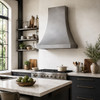 Smooth natural zinc bell range hood in industrial kitchen with bright wall, window and island
