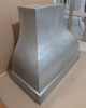 Discount wall mount zinc range hood finishing detail, smooth zinc surface with aged patina texture and clean metal edging