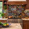 Mexican relief tile pattern mix in a rustic kitchen backsplash wall