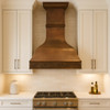 Large kitchen copper range hood in a transitional style kitchen