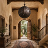 Moroccan-style spherical pendant lamp shade illuminating an old-world entry hall with wood decor