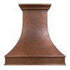Hand-hammered bell copper range hood with architectural apron, crown molding, and sweeping curved canopy