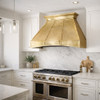 Tin range hood in a transitional kitchen with clean panels, riveted seams, mixed metals and stone surfaces